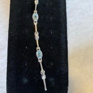 Silver bracelet with blue topaz stones.